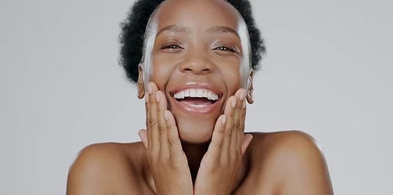happy black woman with glowing skin after skin brightening facial